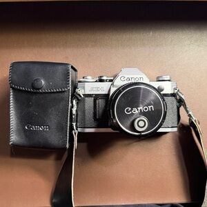 Canon AE-1 Silver and Black 35mm SLR Camera with Black Carrying Case